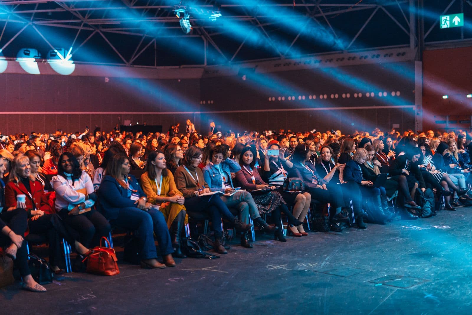 An audience seated in an auditorium during a live presentation