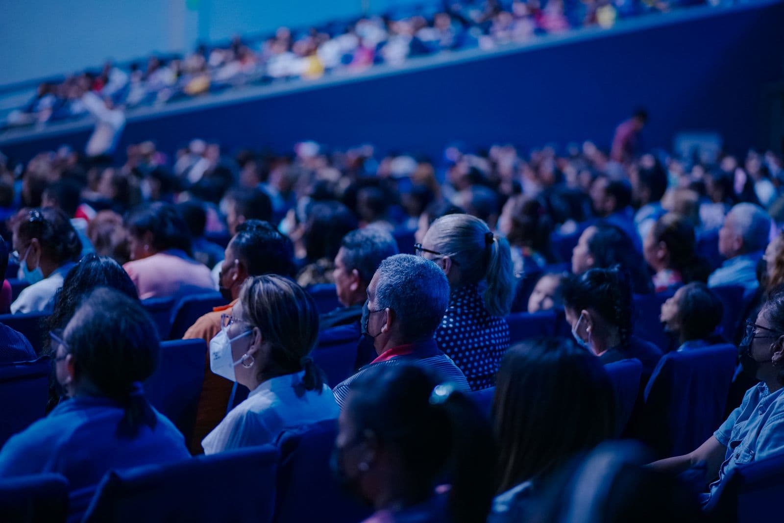 Attendees seated in rows watching a presentation at an event