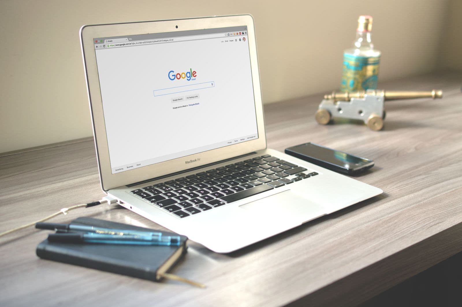An open laptop showing a website homepage on a bright desk