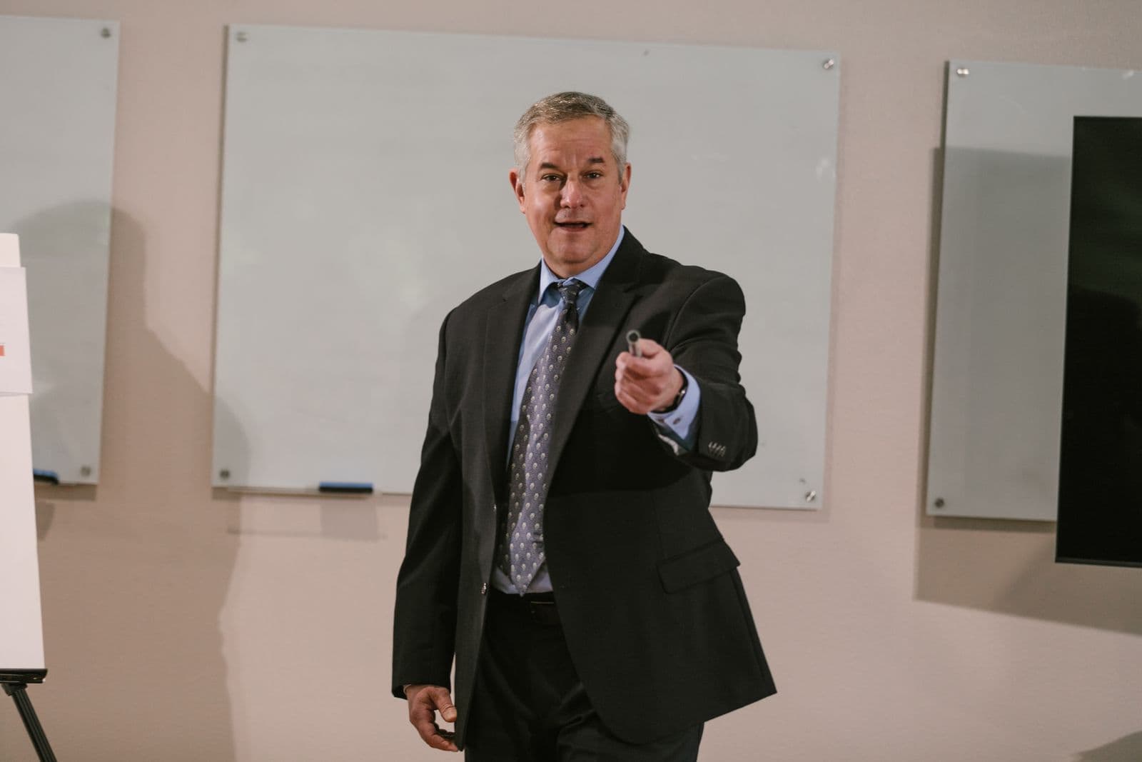 A presenter speaking to a seated audience in a conference room