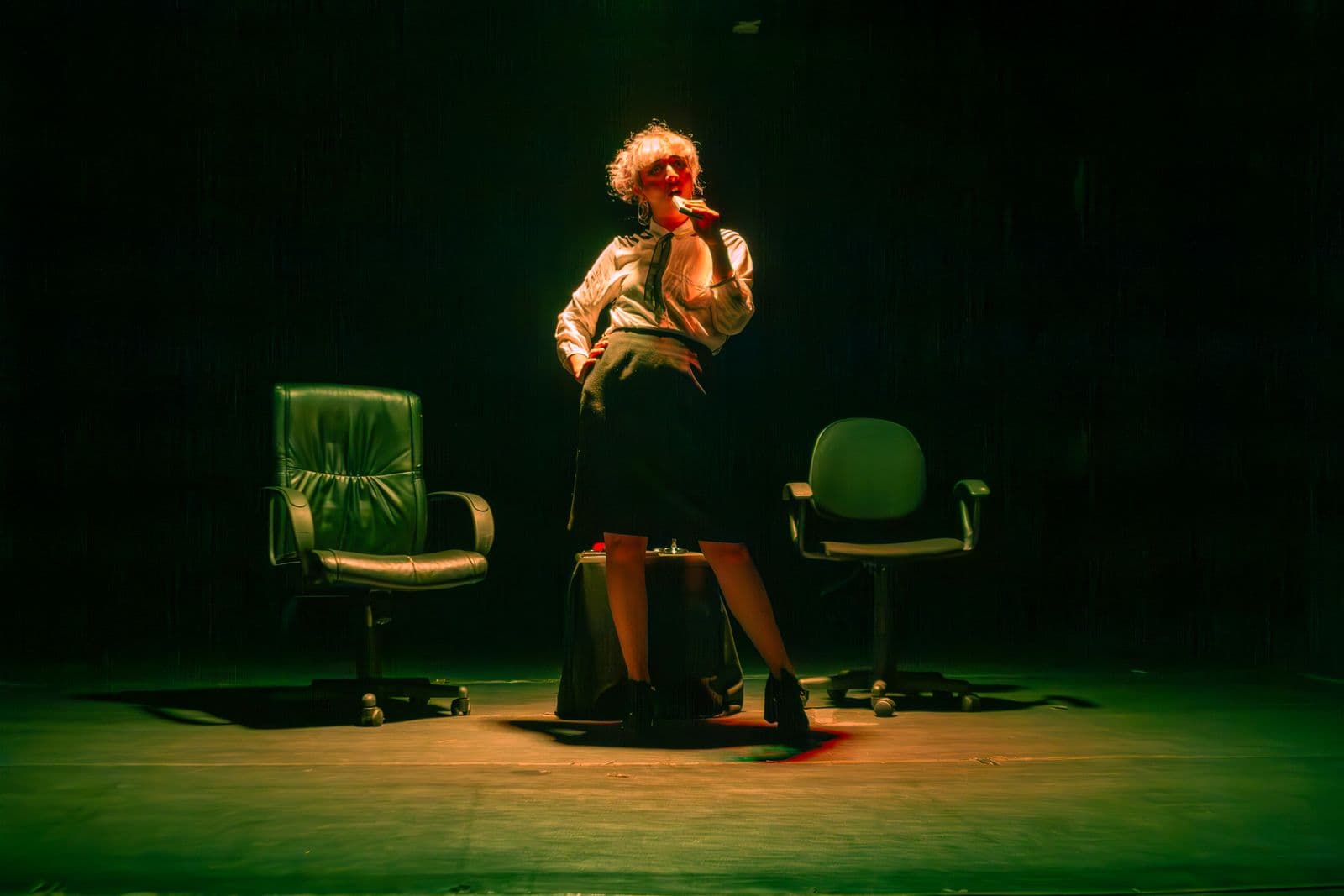 A single spotlight cutting through darkness onto an empty stage